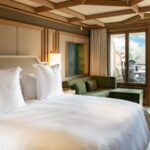 Guest bedroom with a view at The Park Gstaad hotel in Switzerland, part of the historic property reopening as a Four Seasons hotel for winter 2026–27