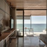 Seaview Terrace Suite at Dexamenes with folding floor-to-ceiling windows opening to a wide veranda