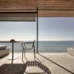 Seaview Terrace Suite at Dexamenes with folding floor-to-ceiling windows opening to a wide veranda