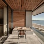 Seaview Terrace Suite at Dexamenes with folding floor-to-ceiling windows opening to a wide veranda