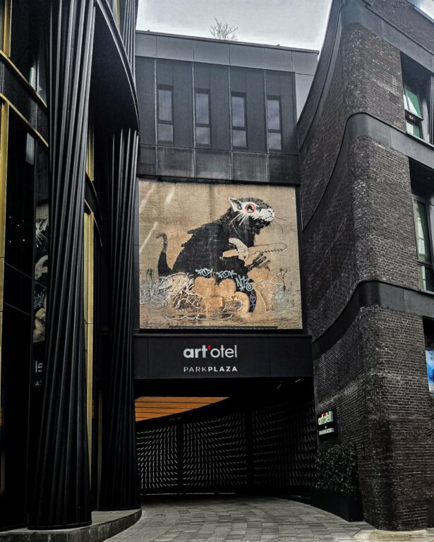Banksy rat stencil artwork above the entrance of art'otel London Hoxton in Shoreditch London